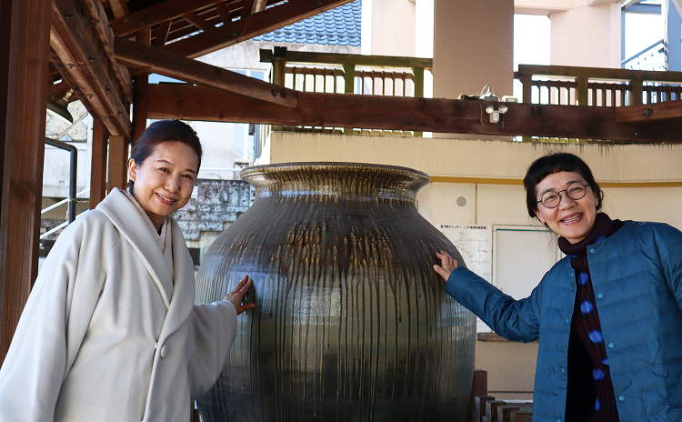 益子駅の大きな益子焼の壺の前で記念撮影をする編集者とそめおりさんの写真